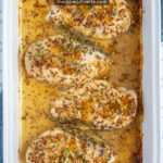 Pinterest Pin with text overlay 'Baked Honey Mustard Chicken Breasts', image of a white casserole dish with four baked chicken breasts with honey mustard sauce.
