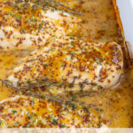 Pinterest Pin with text overlay 'Baked Honey Mustard Chicken Breasts', image of a white casserole dish with four baked chicken breasts with honey mustard sauce.