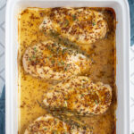 Pinterest Pin with text overlay 'Baked Honey Mustard Chicken Breasts', image of a white casserole dish with four baked chicken breasts with honey mustard sauce.