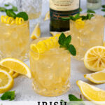 Pinterest Pin with text overlay 'Irish Lemonade', image of whiskey glass filled with ice and Irish lemonade garnished with lemon peel and mint.