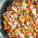 Pinterest pin with text overlay 'Turkey & Sweet Potato Skillet', image of turkey, sweet potatoes, and black beans in a cast iron skillet.