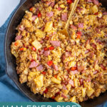 Pinterest pin with text 'Ham Fried Rice with Pineapple', image of black skillet with fried rice and a serving spoon.
