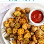 Pinterest Pin with text overlay 'Air Fryer Home Fries', image on baby potato home fries on a plate with a fork.