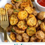 Pinterest Pin with text overlay 'Air Fryer Home Fries', image on baby potato home fries on a plate with a fork.