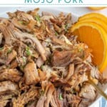 Pinterest Pin with text overlay 'Crockpot Mojo Pork', image of bowl of mojo pulled pork.