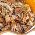 Pinterest Pin with text overlay 'Slow Cooker Cuban Mojo Pork', image of bowl of mojo pulled pork.