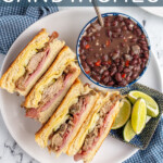 Pinterest Pin with text overlay 'Cuban sandwiches', image of a sandwich cut in half and stacked on top of each other showing off the insides.