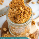 Pinterest Pin with text overlay 'Peanut Butter Granola, image on chunky peanut butter granola in a jar.