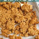 Pinterest Pin with text overlay 'Peanut Butter Granola, image on chunky peanut butter granola on a sheet pan.