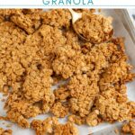 Pinterest Pin with text overlay 'Peanut Butter Granola, image on chunky peanut butter granola on a sheet pan.