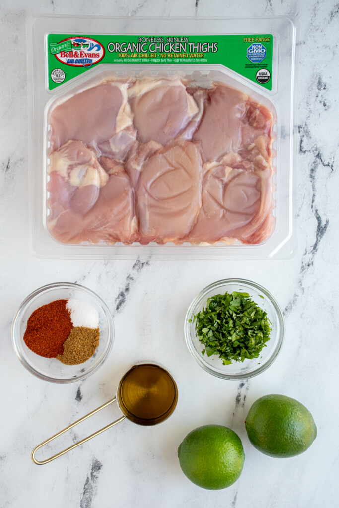 Ingredients for grilled chicken street tacos laid out on a table top.