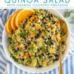 Pinterest Pin with text overlay 'Black bean Quinoa Salad with Orange Cilantro Dressing', image of a white bowl filled with black bean quinoa salad garnish with cilantro.