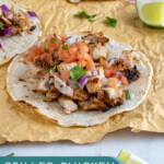 Pinterest Pin with text overlay 'Grilled Chicken Street Tacos', image of grilled chicken taco with toppings.