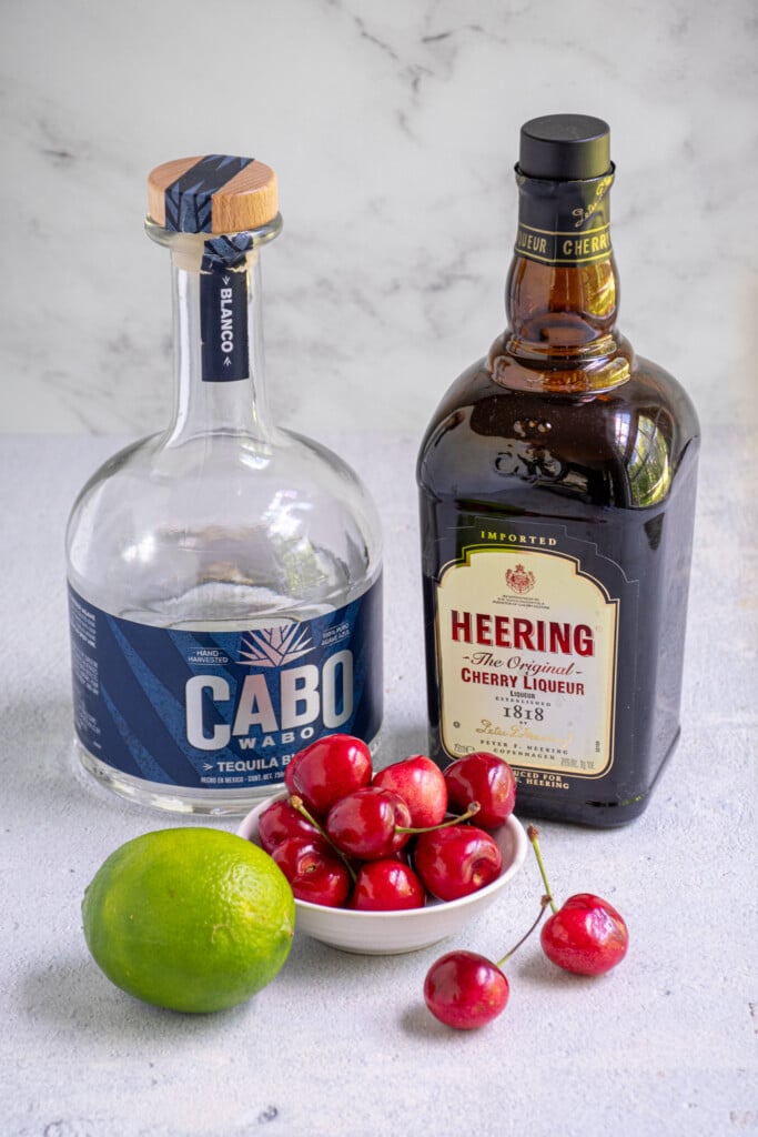 Ingredients needed to make a fresh cherry margarita.
