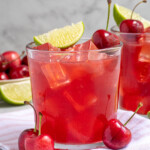 Pinterest pin with text overlay 'Fresh Cherry Margaritas', image of a glass with ice and a red cherry margarita.