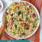 Pinterest Pin with text overlay 'Mediterranean Orzo Pasta Salad', image of a white bowl filled with colorful pasta salad with a wooden spoon.