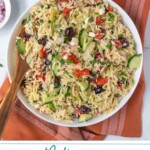 Pinterest Pin with text overlay 'Mediterranean Orzo Pasta Salad', image of a white bowl filled with colorful pasta salad with a wooden spoon.