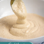 Pinterest pin with text overlay 'Greek Yogurt Caesar Dressing', image of Greek Yogurt Caesar Dressing in a white bowl with a spoon.
