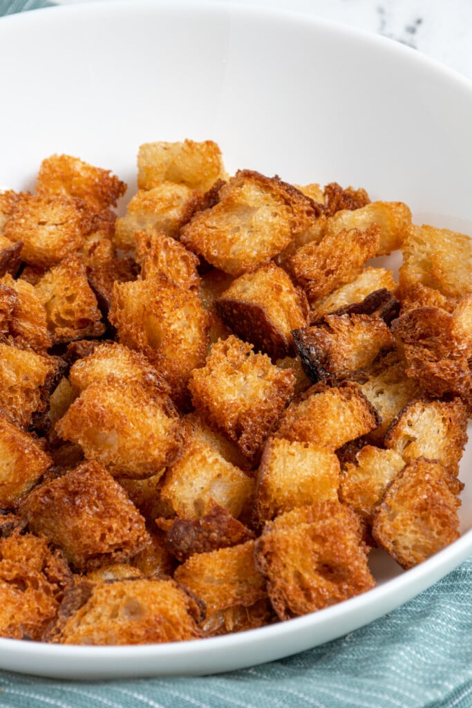 Close up of Air Fryer Croutons in a white bowl.