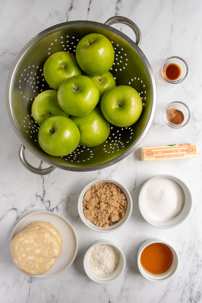 Ingredients needed to make homemade apple pie with fresh apples.