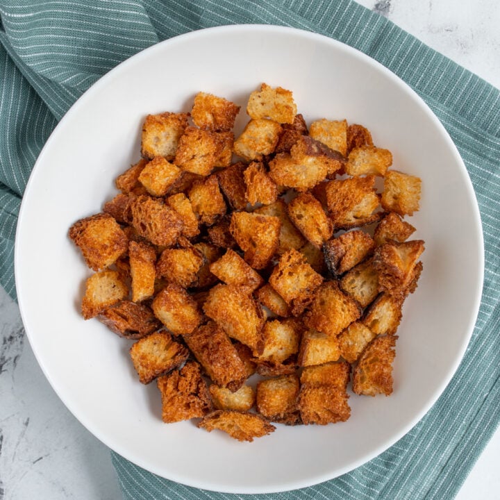 Overhead view of Air Fryer Croutons in a white bowl.