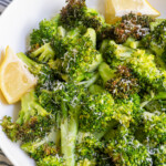 Pinterest pin with text overlay "Air Fryer Broccoli", image of a white bowl with cooked broccoli.