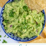 Pinterest pin with text overlay 'Simple Guacamole', image of a blu bowl filled with homemade guacamole with a tortilla chip.