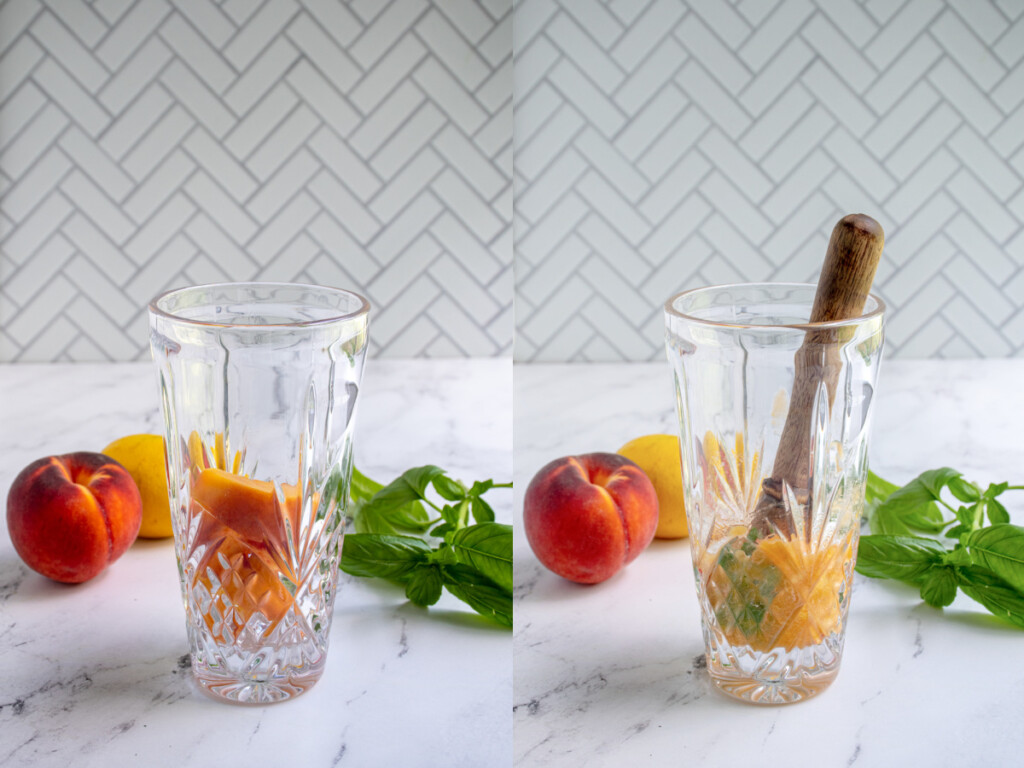 A bar shaker with slices of peaches and then them being muddled down with basil to make a bourbon peach smash.