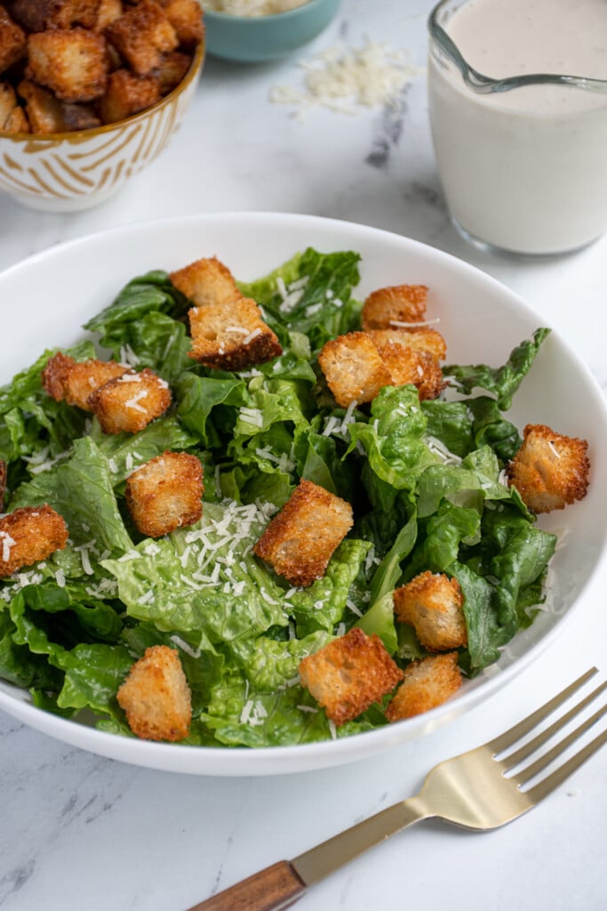 Air fryer croutons in a salad of lettuce.