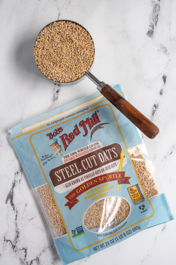 Steel cut oats in a bag and in a measuring cup.