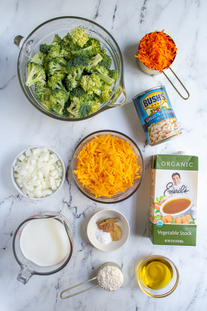 Ingredients needed to make healthy broccoli cheese soup laid out on a tabletop.