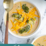 Pinterest pin with text overlay 'Healthy Broccoli Cheese Soup', image of white bowl filled with broccoli and cheese soup.