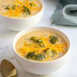 Pinterest pin with text overlay 'Healthy Broccoli Cheese Soup', image of white bowl filled with broccoli and cheese soup.