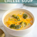 Pinterest pin with text overlay 'Healthy Broccoli Cheese Soup', image of white bowl filled with broccoli and cheese soup.
