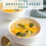 Pinterest pin with text overlay 'Healthy Broccoli Cheese Soup', image of white bowl filled with broccoli and cheese soup.