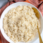 Pinterest Pin with 'The Schmidty Wife' Logo, image of bowl of risotto and serving spoon.
