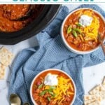 Pinterest pin with text 'the best Crockpot Classic Chili', image of white bowl with chili and garnishes.