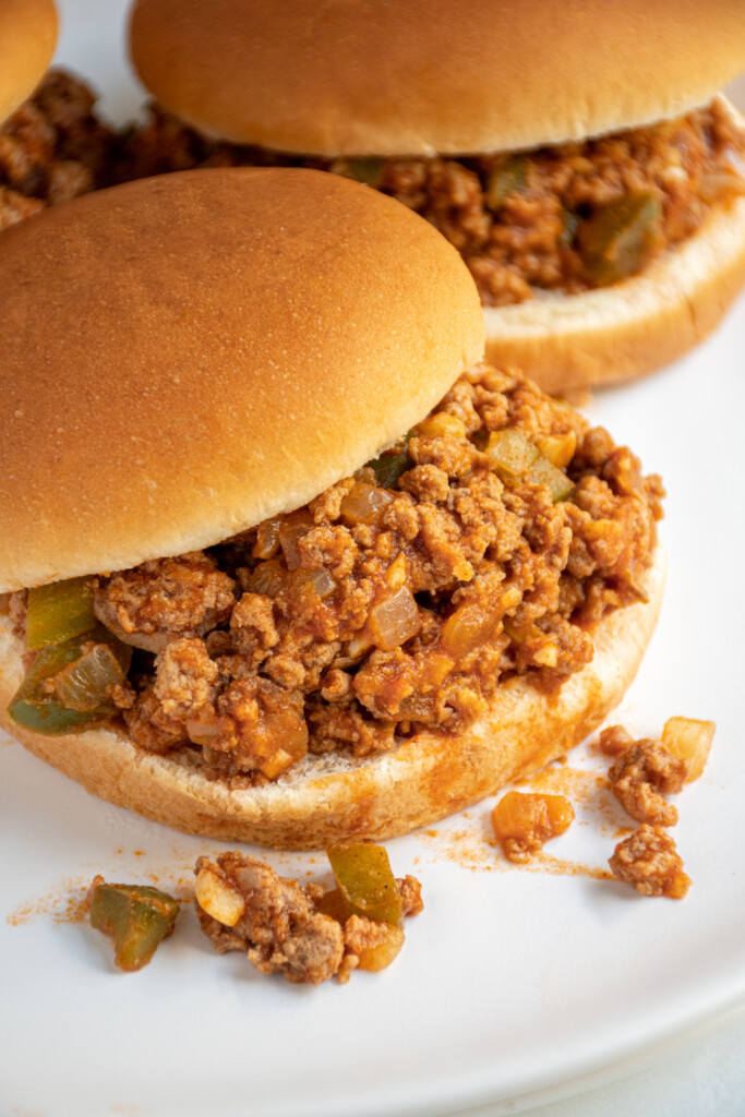 Close up of ground turkey sloppy joes in a bun.