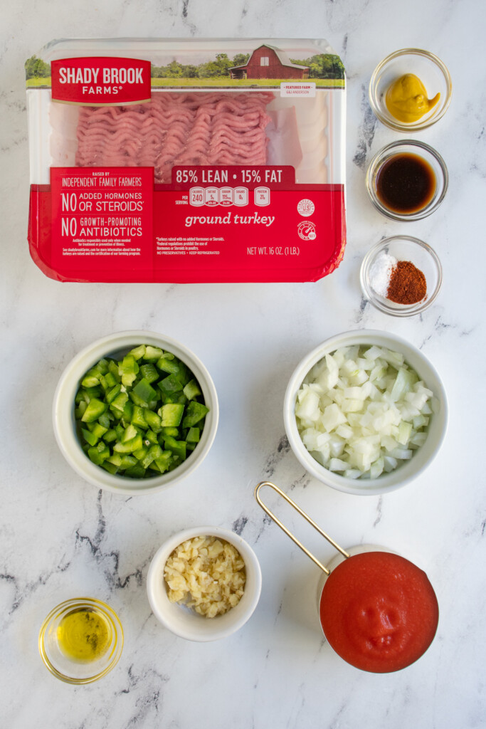 Ingredients needed to make ground turkey sloppy joes laid out on a tabletop.