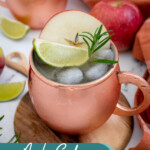 Pinterest pin with text overlay 'Apple Cider Moscow Mule', image of a copper mug full of apple cider mule garnished with apple, rosemary, and lime.