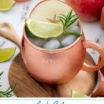 Pinterest pin with text overlay 'Apple Cider Moscow Mule', image of a copper mug full of apple cider mule garnished with apple, rosemary, and lime.