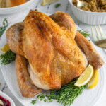 Pinterest pin with logo 'The Schmidty Wife', image of a thanksgiving turkey on a white platter.