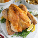 Pinterest pin with text overlay 'Easy No-Fuss Roast Turkey', image of a thanksgiving turkey on a white platter.