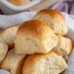 Pinterest pin with text over lay 'Homemade Dinner Rolls', image of a linen filled with a pile of soft homemade dinner rolls.