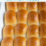 Pinterest pin with text over lay 'Homemade Dinner Rolls', image of a linen filled with a pile of soft homemade dinner rolls.