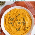 Pinterest pin with text "Pumpkin Hummus", image of a white bowl with orange pumpkin hummus garnished with olive oil and pumpkin seeds.