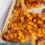 Pinterest pin with text overlay 'Maple Roasted Butternut Squash', image os a sheet pan with cooked squash and pecans.