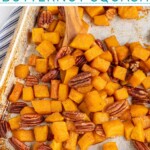 Pinterest pin with text overlay 'Maple Roasted Butternut Squash', image os a sheet pan with cooked squash and pecans.