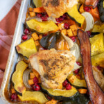 Pinterest pin with text overlay 'One Pan Autumn Chicken Dinner', image of a sheet pan with veggies and chicken thighs.