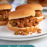 Pinterest Pin with text over lay 'Ground Turkey Sloppy Joes", image of a bun filled with sloppy joes on a plate.